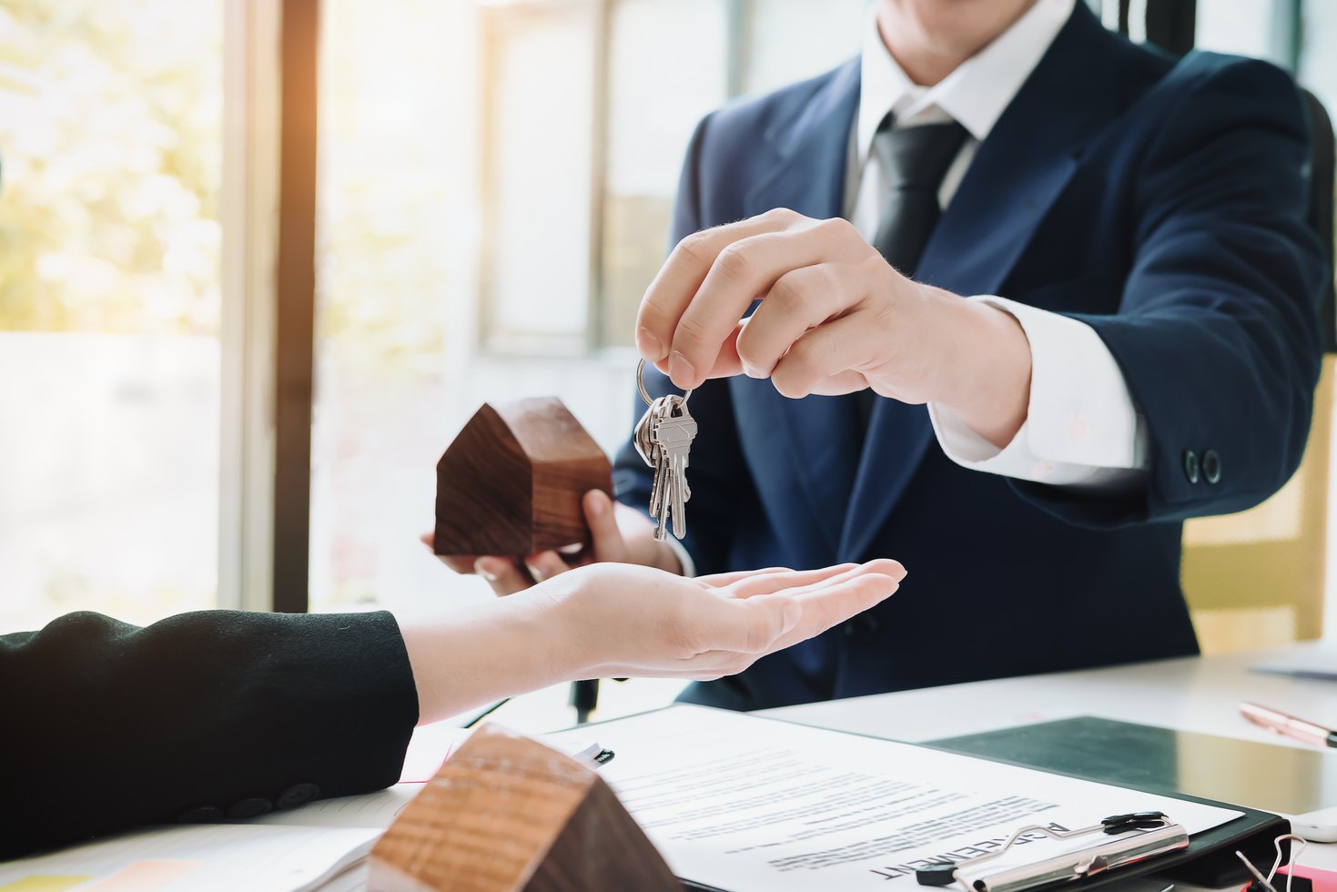 Real Estate Agent Holding House Key to His Client